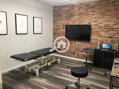 Clinic for Sale in New Cairo, Cairo - Chiropractic Adjustment Area with Exposed Brick. jpeg