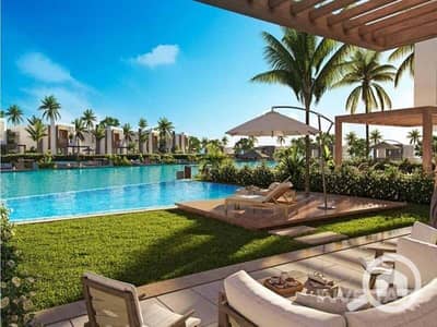 2 Bedroom Chalet for Sale in North Coast, Matruh - exterior-pool-view-hacienda-bay-water-villas-north-coast-palm-hills-2. jpeg