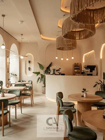 Restaurant & Cafe for Rent in New Cairo, Cairo - Warm and Inviting Cafe Interior with Soft Lighting Accents. jpg