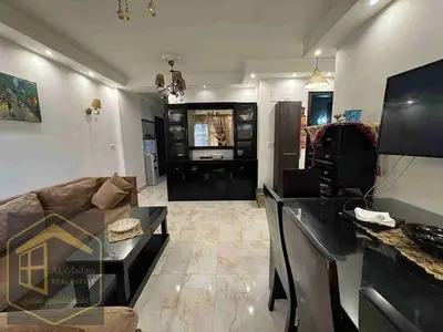 Furnished hotel apartment for rent in Madinaty. A unique opportunity for upscale and comfortable living in a very vibrant location. The apartment has two rooms and a living room + kitchen + bathroom, fully furnished with modern hotel furniture, fully air-conditioned with very modern and stylish finishes. The location is very distinctive: next to the Strip Mall and close to Craft Zone.
