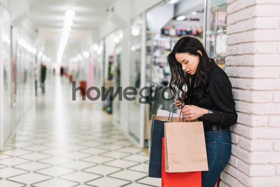 8 woman-with-paper-bags-modern-mall. jpg