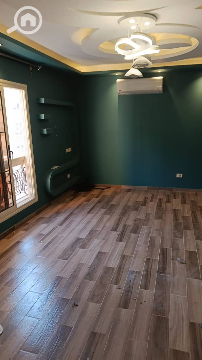 Apartment for rent, 4 rooms and 2 bathrooms in Al-Miraj Al-A'la, Carrefour Main Street, very close to the Fifty Mall. The apartment has 2 balconies, gas and internet available, a kitchen unit, a stove, and 4 air conditioners in the rooms. The apartment also has a garage space. The area of the apartment is 220 square meters, in a prime location near all services. - Mehr