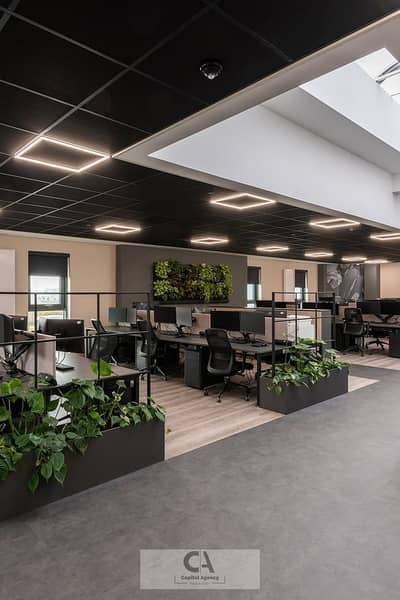 Office for Rent in New Cairo, Cairo - Inside an open-plan office space in Derby. jpeg
