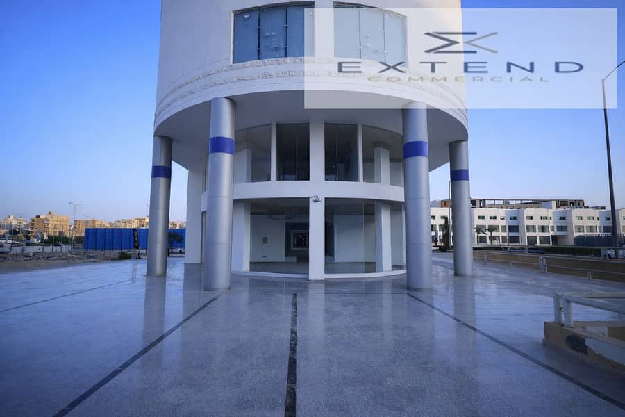 7 Modern cylindrical building on urban street. png