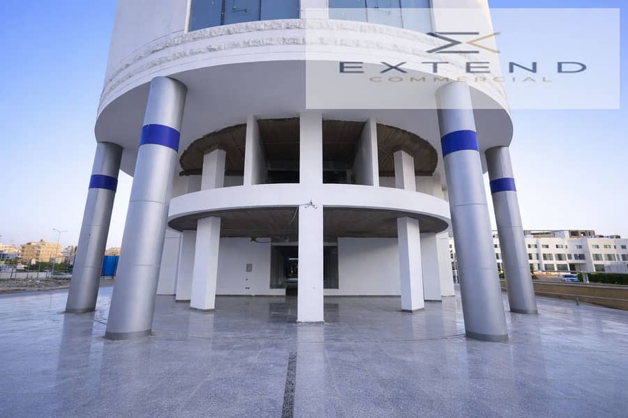 8 Modern cylindrical building at sunset. png