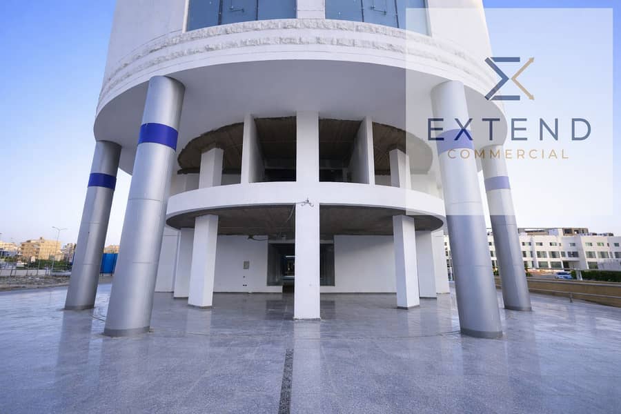 6 Modern cylindrical building at sunset. png