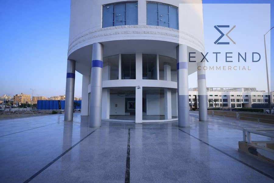 9 Modern cylindrical building on urban street. png