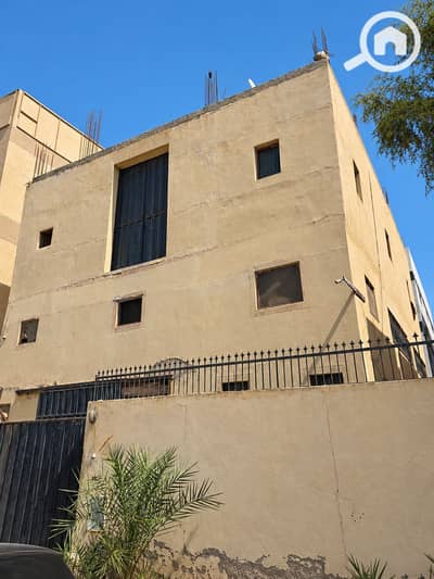 Industrial for Sale in 10th of Ramadan, Sharqia - Egyptian Factory Exterior Under Clear Blue Sky-1. png