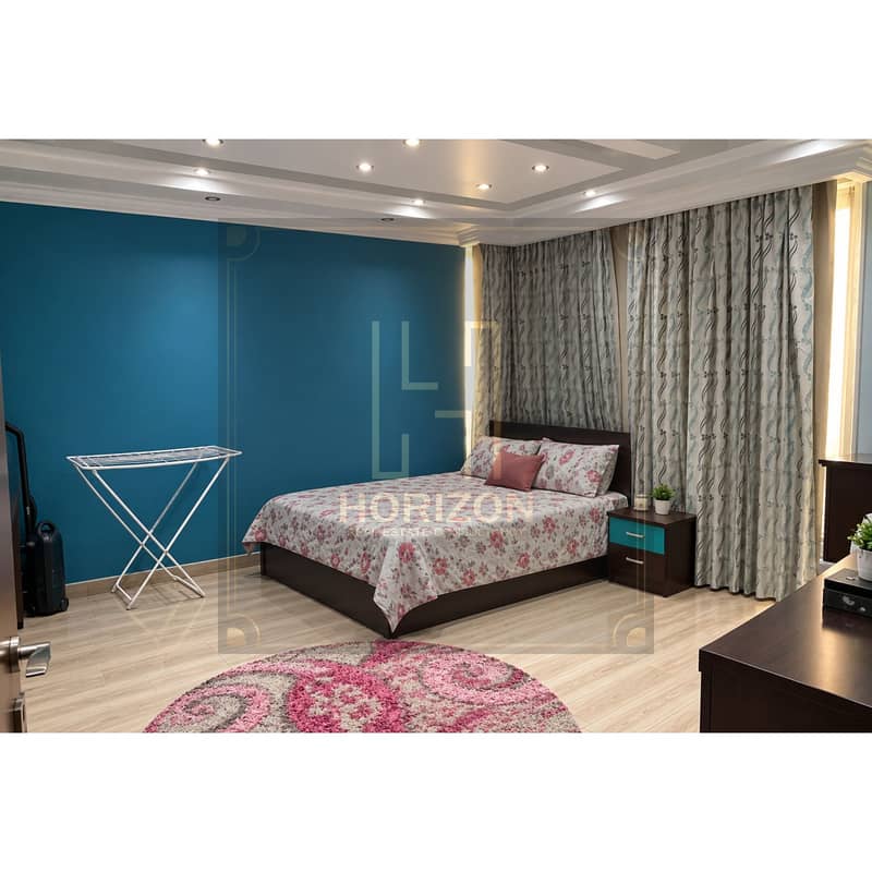 7 Tidy Teal Bedroom with Floral Bedspread. jpg