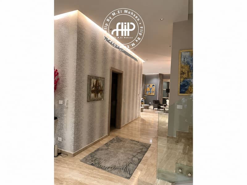 7 Modern Hallway Opening to Luxe Living Room. png