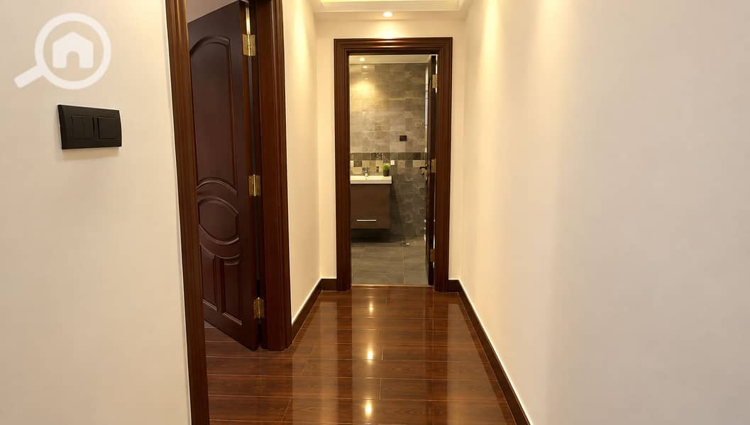 7 Warm Modern Hallway to Tiled Bathroom. png