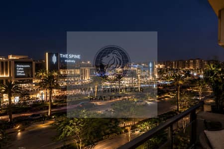 2 Bedroom Flat for Sale in Madinaty, Cairo - Nighttime Boulevard at The Spine. png