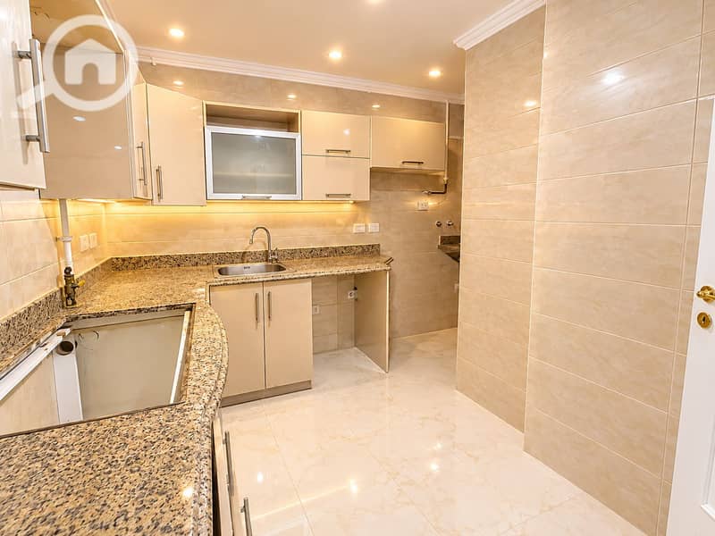 4 Glossy Beige Kitchen with Granite Countertops. png
