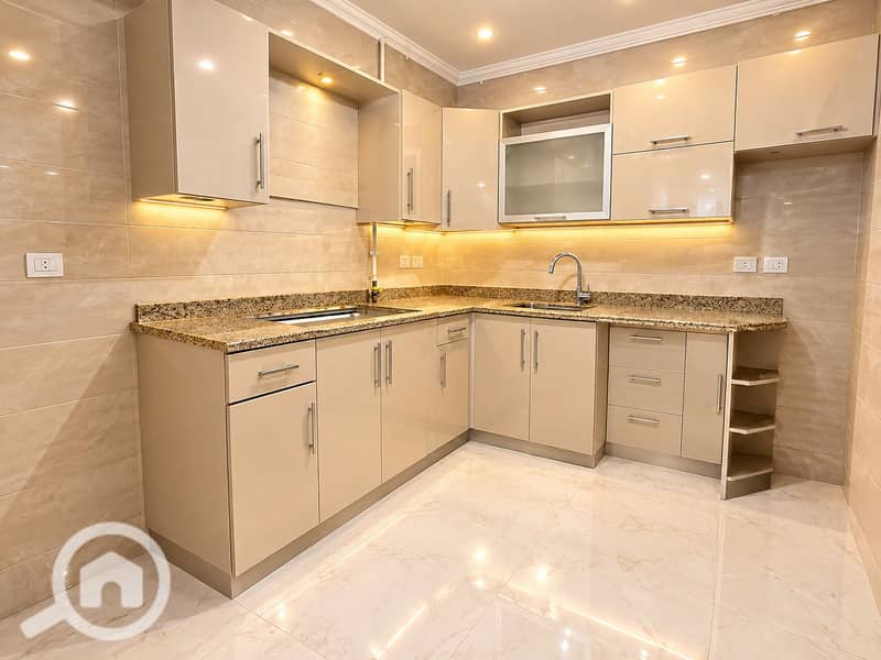 5 Glossy Cream L-Shaped Modern Kitchen. png