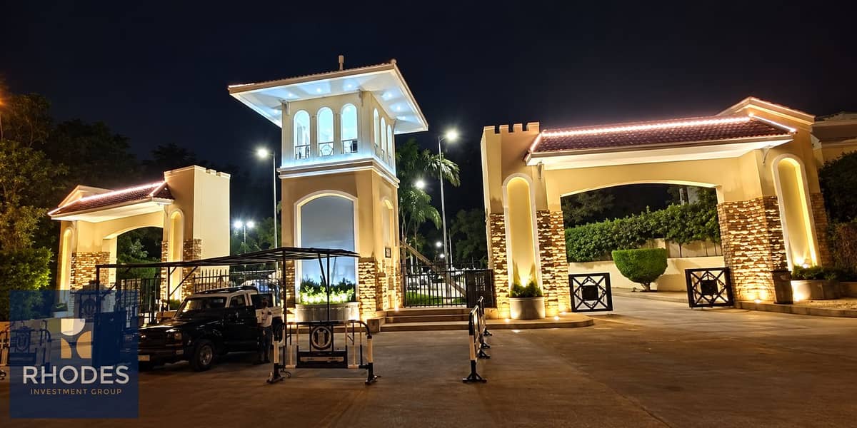 2 Illuminated Grand Gated Entrance at Night. png