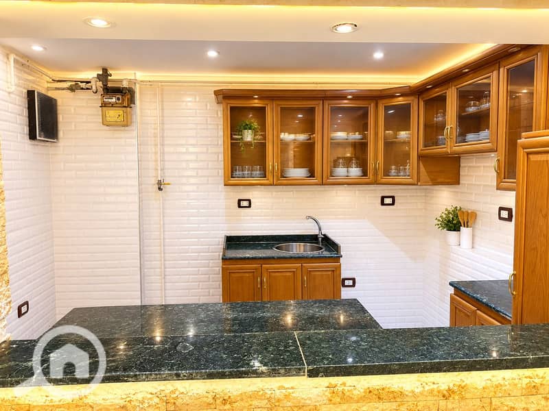 3 Polished Warm Wood and Green Marble Kitchen. png