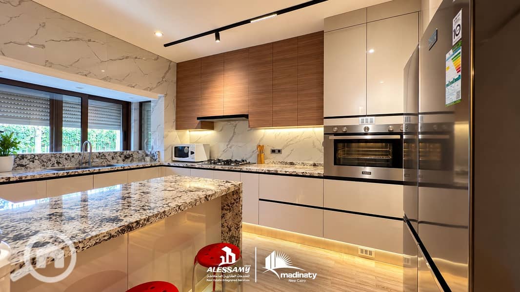 14 luxury_standalone_villa_for_sale_in_madinatyElegant Marble and Wood Modern Kitchen. png