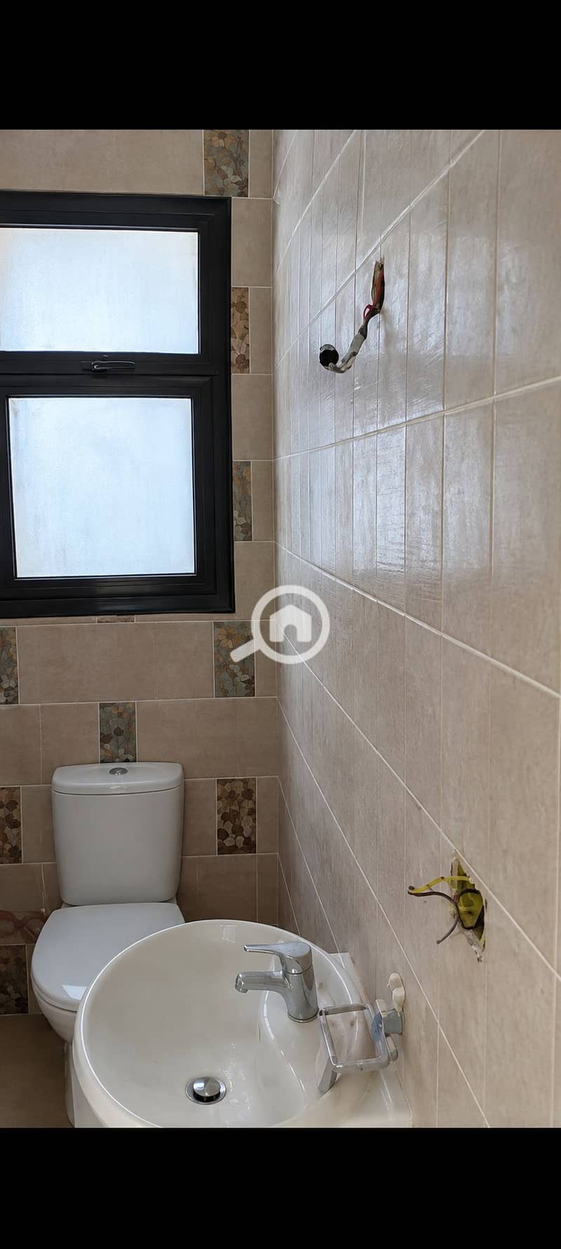4 Compact Beige Bathroom with Exposed Wiring. png