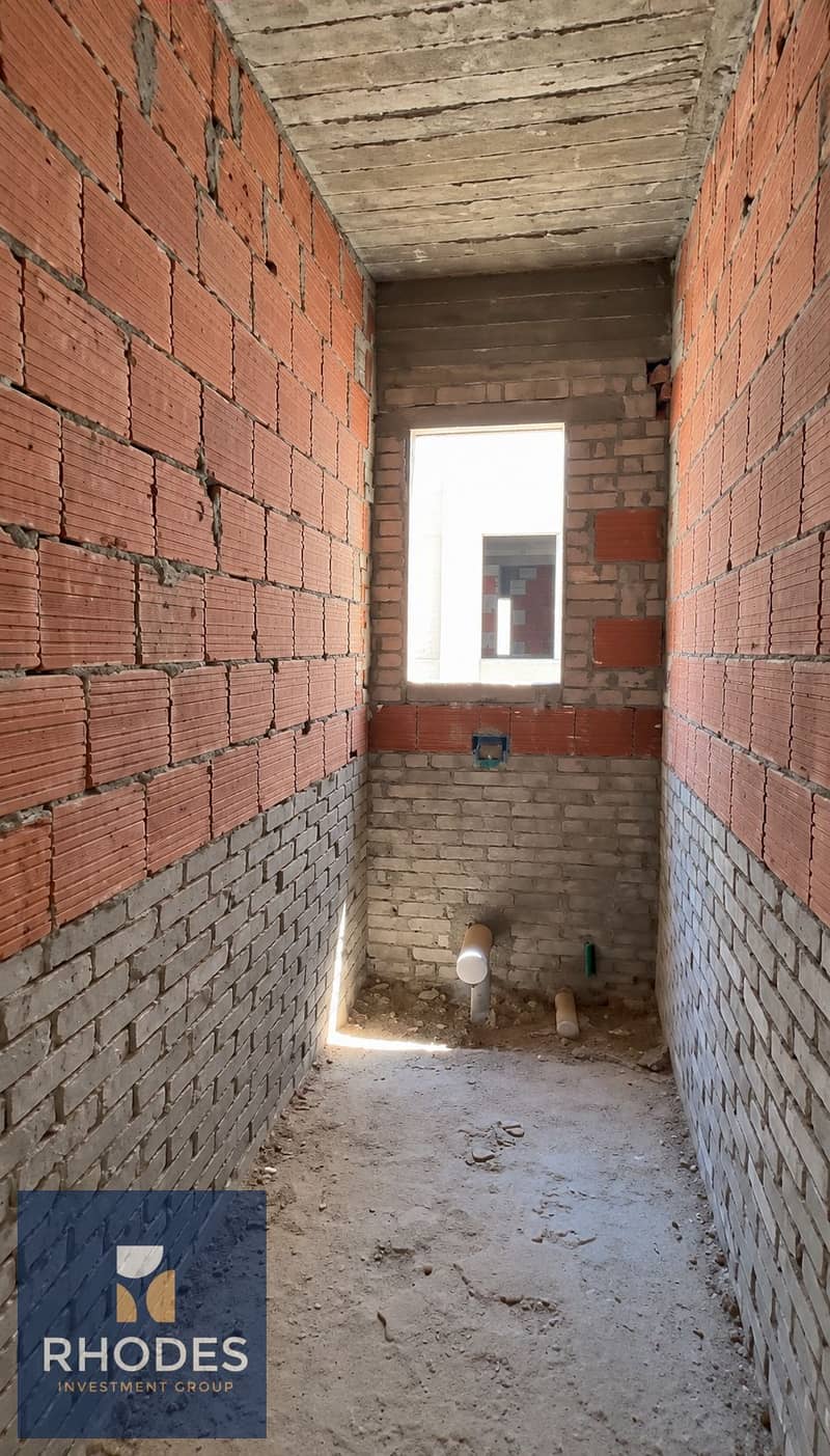 9 Unfinished Brick Corridor with Sunlit Window. png