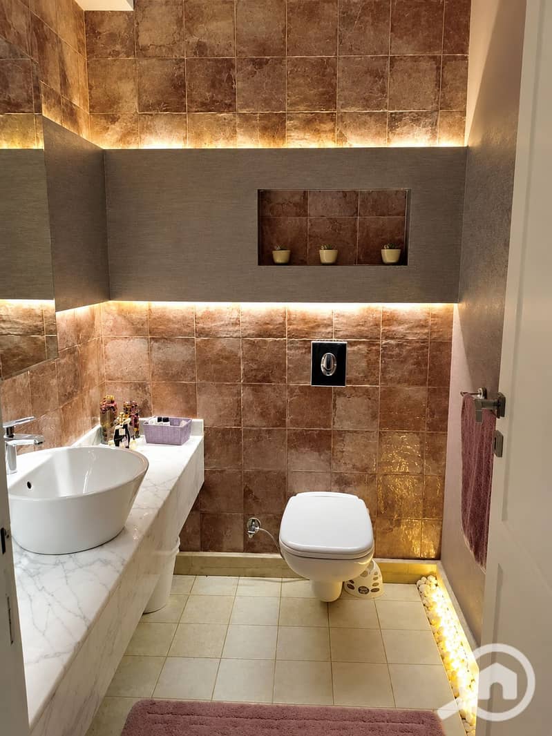 8 Luxurious Warmly Lit Marble Bathroom. png