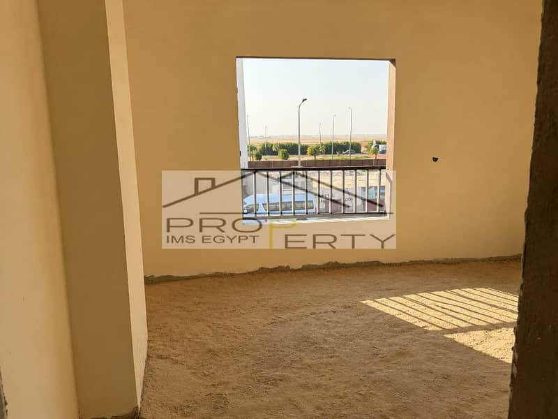 2 Sunlit Unfinished Room with Balcony View. png
