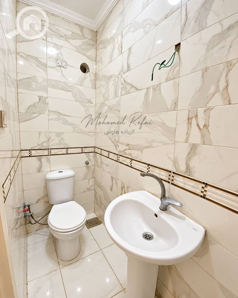 5 Polished Marble-Tiled Bathroom Interior. png